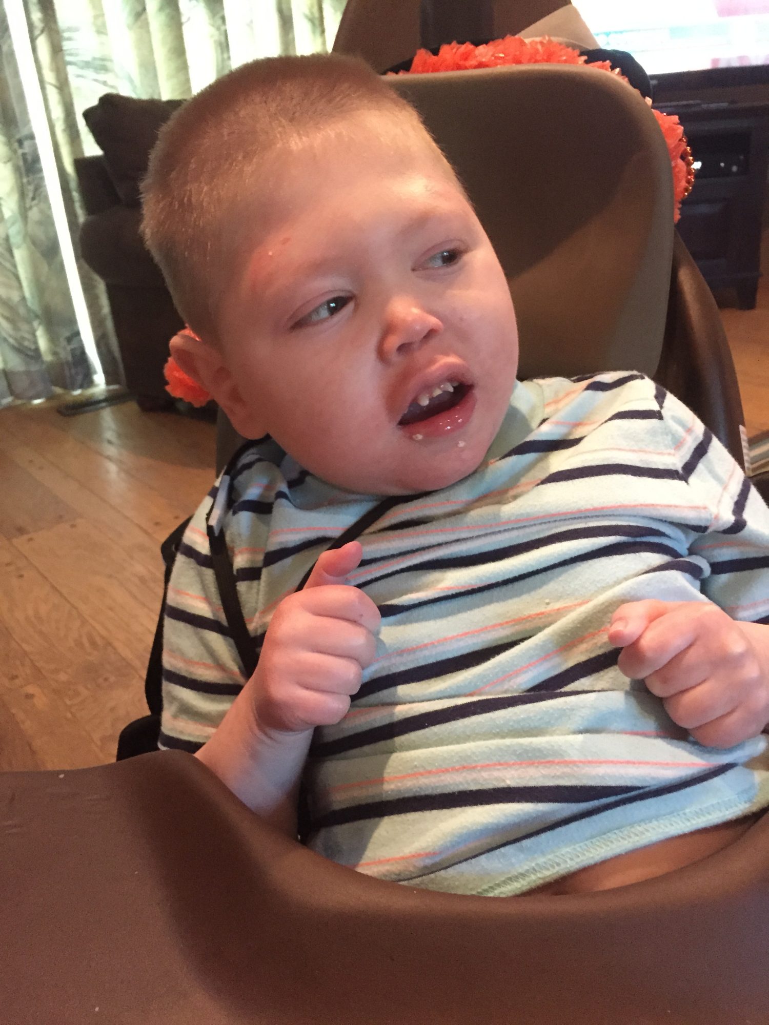 Photo of a medically complex boy in adaptive seating